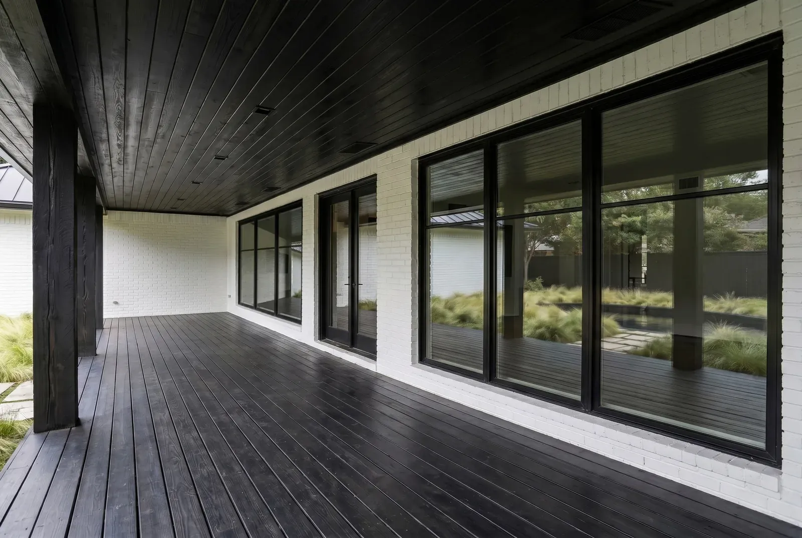 Exterior remodel in East Austin, Austin, TX with a blackened wood porch ceiling and deck