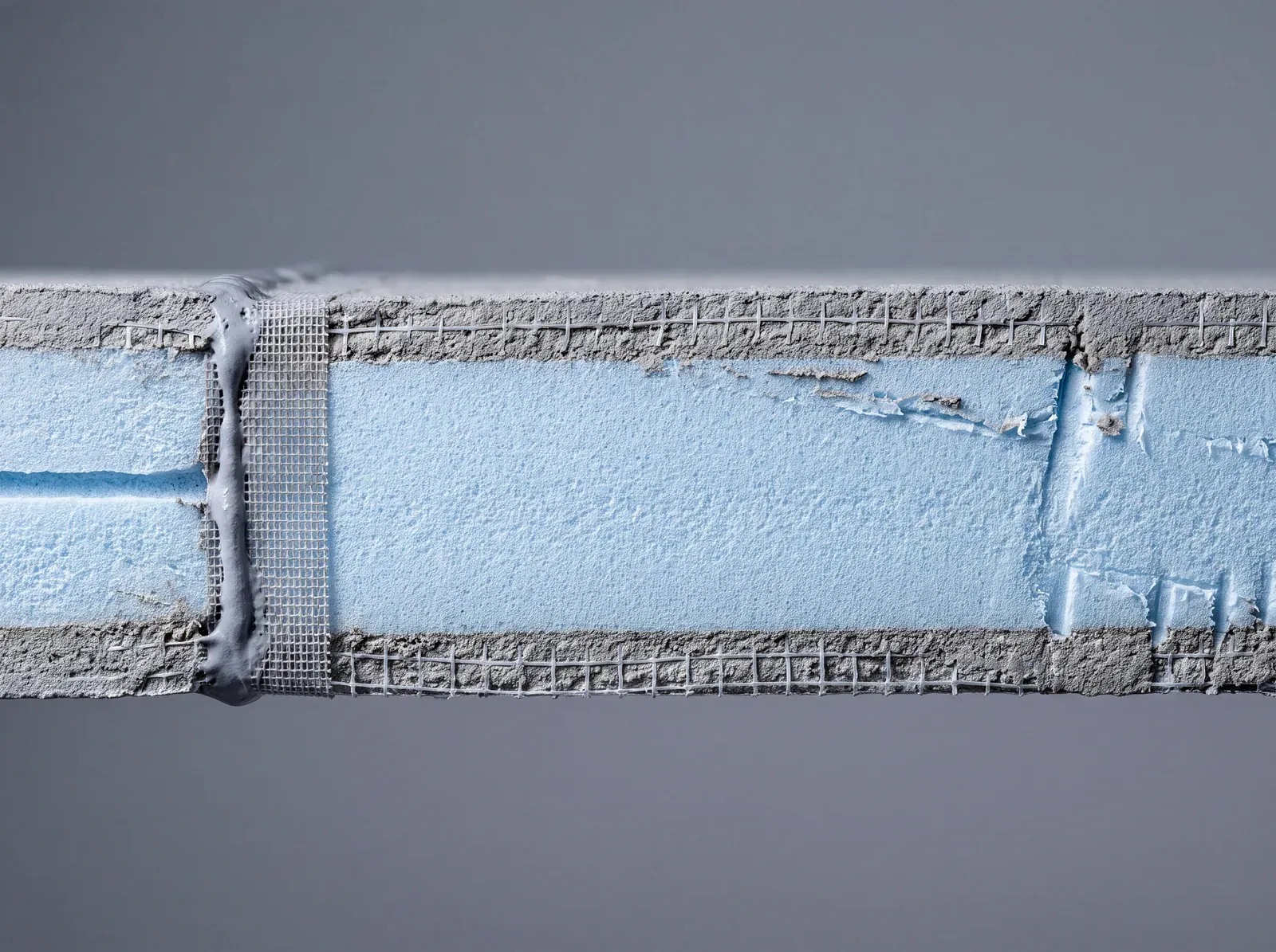 Foam shower panel cross-section: blue XPS core with cement-resin coating and embedded mesh on both faces