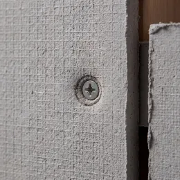 Cement board face with recessed corrosion-resistant screw