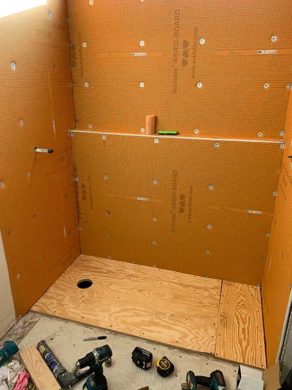 Orange Kerdi-Board panels installed in a shower surround