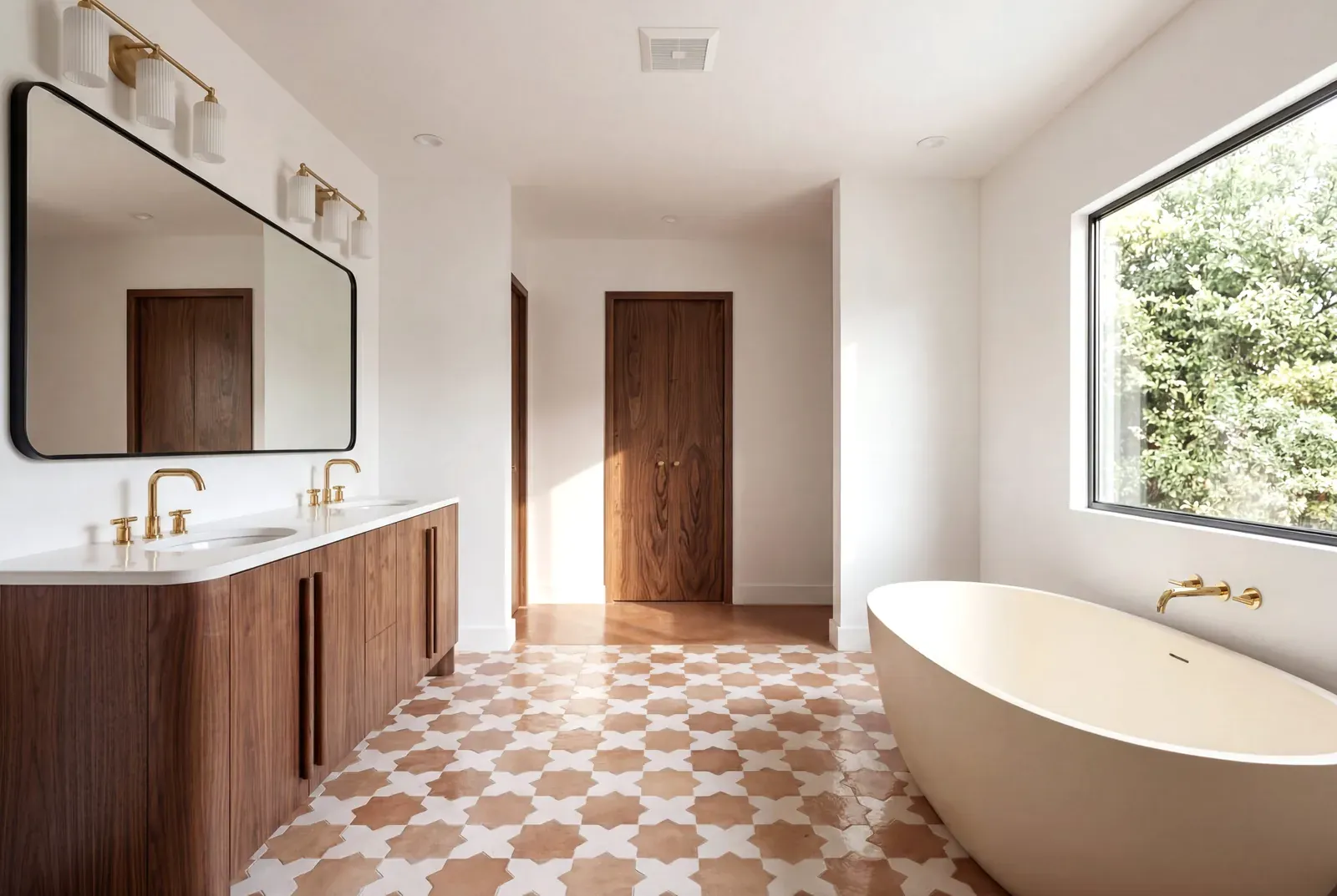Primary bathroom with a walnut double vanity, a freestanding tub under a picture window and a patterned terracotta tile floor
