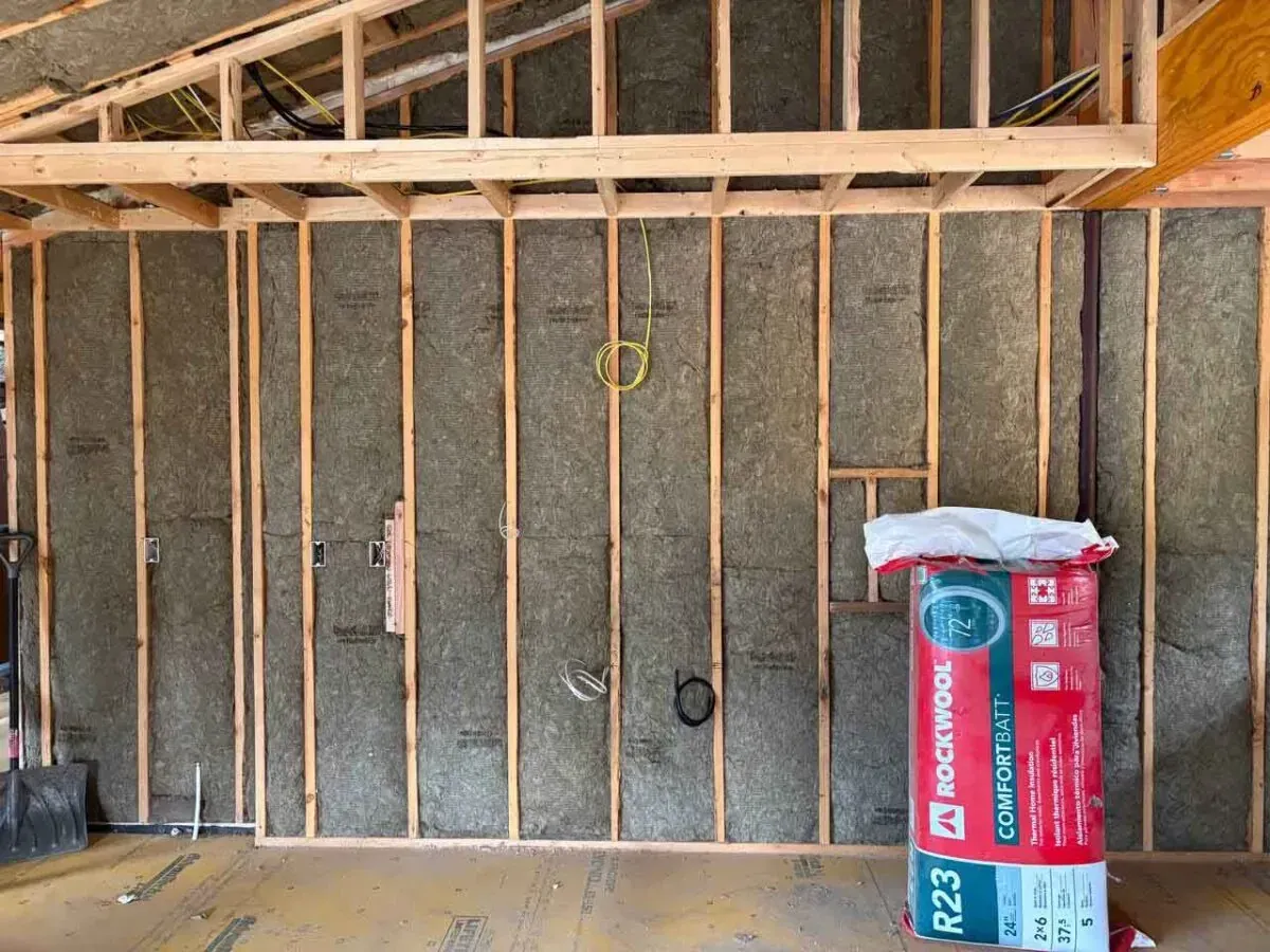 Rockwool mineral wool batts filling a full framed wall on a renovation job site